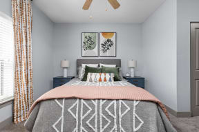 a bedroom with a bed and a ceiling fan at the Vue luxury apartments in Indianapolis