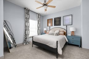 a bedroom with a bed and a ceiling fan