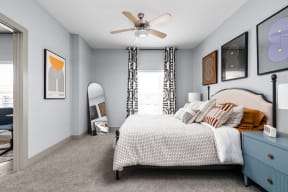 a bedroom with a bed and a ceiling fan