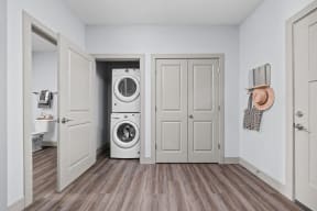 a small laundry room with a washer and dryer and a door to a