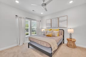 a bedroom with a bed and a ceiling fan at spire luxury apartments