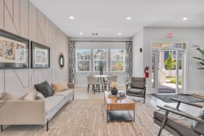community living room with a couch and a table   at spire luxury apartments in charlotte nc