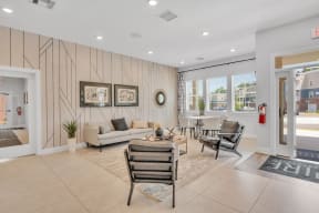 community living room with a couch and chairs and a table at spire luxury apartments in charlotte nc