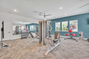 fitness center with cardio equipment and weights at spire apartments