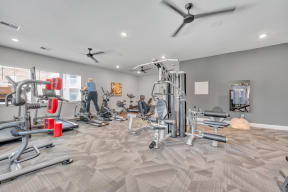 fitness center with cardio equipment and weights at spire apartments