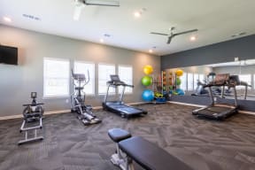 Fitness center with treadmills, a rower, and bench