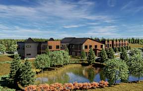 A modern building complex with a pond in front.