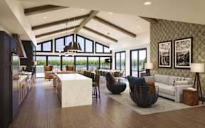 A modern kitchen with a large island and a dining area with a view.