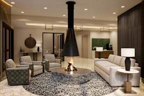 A modern living room with a fireplace and comfortable seating.
