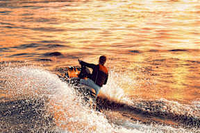 A person is surfing on a wave.