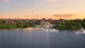 A row of houses are built on a peninsula over water.
