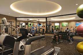 A gym with people working out and sitting.