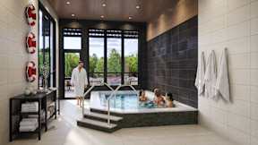 A woman in a white robe stands in a spa room with a hot tub.