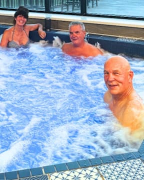 Two people are enjoying a hot tub.