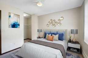 a bedroom with a white bed and blue pillows