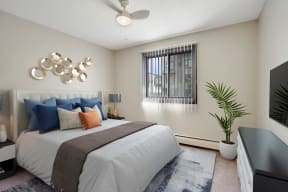 a bedroom with a bed and a ceiling fan