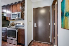 the doorway to a kitchen with a stainless steel stove and a refrigerator