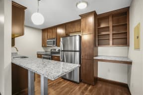a kitchen with stainless steel appliances and a marble counter top