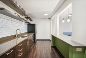 a kitchen with green cabinets and a sink and a refrigerator