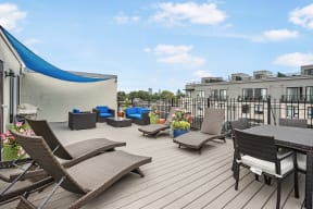 the terrace of a condo with a table and chairs