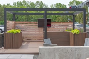 an outdoor entertaining area with a wooden privacy fence and a pergola