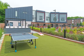 a tennis court with a ping pong paddle in the middle of it in front of a