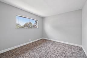 Spacious room with oversized window at Ocean Villas Apartments, Oxnard, California