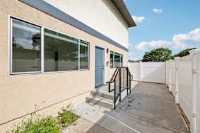 White fence around the building at Ocean Villas Apartments, Oxnard