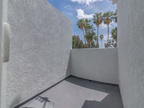 the private balcony has views of the palm trees at Warner Center Townhomes, Canoga Park, CA