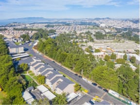 an aerial view of a city with cars parked on a street  at Skyline Heights LLC, Daly City, 94015