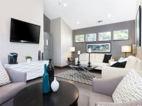 a living room with couches a table and a television  at Skyline Heights LLC, Daly City