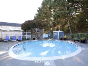 a swimming pool with chairs and a fence around it  at Skyline Heights LLC, Daly City, CA