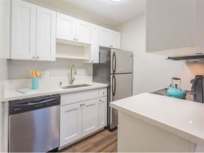 a kitchen with white cabinets and a stainless steel refrigerator  at Skyline Heights LLC, California, 94015