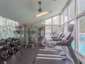 a gym with cardio equipment and windows  at Skyline Heights LLC, Daly City, CA, 94015