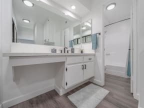 a bathroom with a sink and a mirror  at The Resort at Encinitas Luxury Apartment Homes, California, 92024