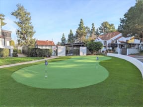 a putting green with houses in the background  at The Resort at Encinitas Luxury Apartment Homes, Encinitas, CA