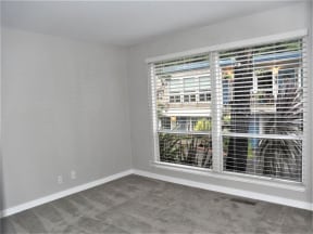 an empty living room with a large window with blinds at Trailhead Apartments at Tam Junction, Mill Valley, 94941