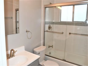 a bathroom with a shower and a sink and a toilet at Trailhead Apartments at Tam Junction, California