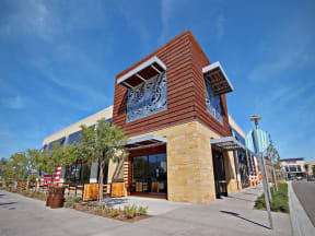 a building with a clock on the front of it at The Vines at Riverpark, LLC, Oxnard, CA 93036