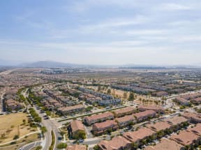 an aerial view of a city with houses and a highway at The Vines at Riverpark, LLC, California