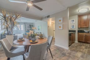 a dining room and kitchen with a table and chairs at City View Apartments at Warner Center, Woodland Hills, CA 91367