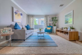 a living room with a couch and a table at City View Apartments at Warner Center, Woodland Hills, CA 91367