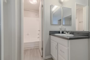 a bathroom with a sink and a mirror at City View Apartments at Warner Center, California, 91367