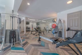 a gym with weights and cardio equipment in a home gym at City View Apartments at Warner Center, Woodland Hills, 91367