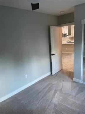 an empty living room with a door to a kitchen at Danville Park, Danville, CA