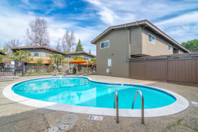 a swimming pool with a house in the background at Element LLC, Sunnyvale, 94086