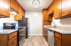 a kitchen with wooden cabinets and stainless steel appliances at Element LLC, Sunnyvale