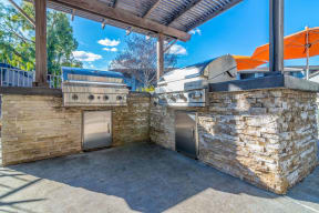 the outdoor kitchen has a grill and two bbqs at Sunnyvale Crossings Apartments, LLC, Sunnyvale, CA 94087