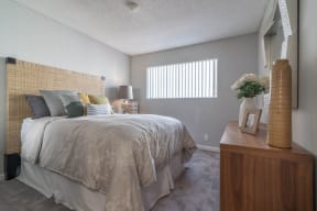 a bedroom with a bed and a dresser and a window at Sunnyvale Crossings Apartments, LLC, California