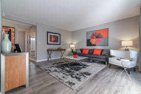 a living room with a couch and a tableat Sunnyvale Crossings Apartments, LLC, Sunnyvale, CA